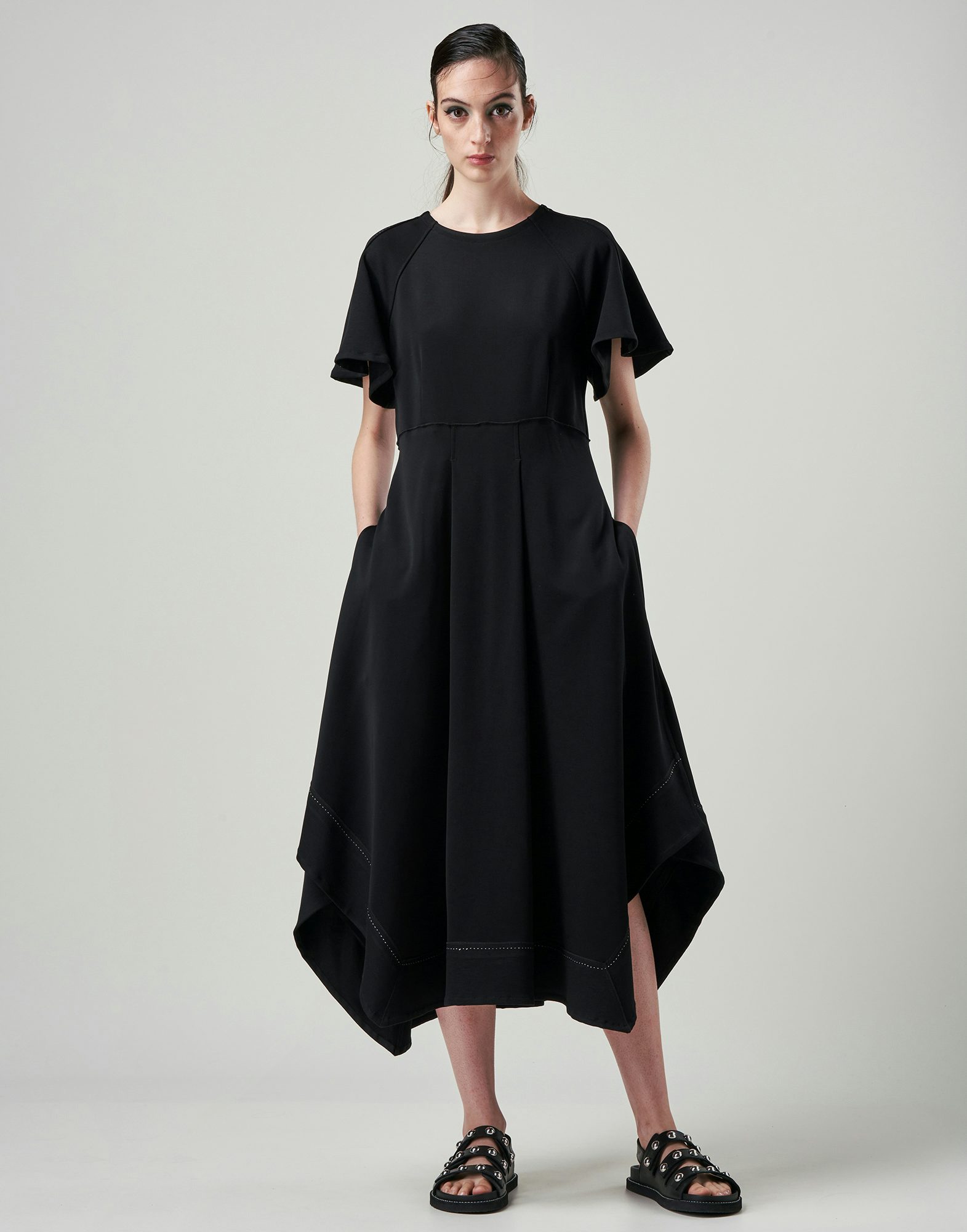 INSTINCT: Black dress with a multi-point skirt